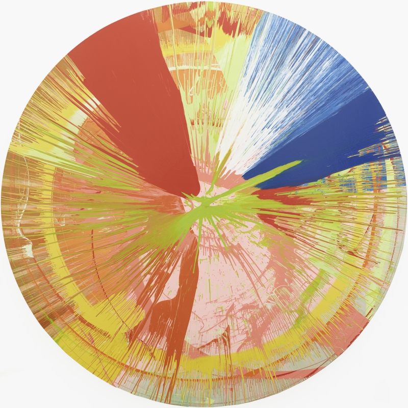 The artwork shows a large, round picture. The colors run in many rays from the center outwards. You can see strong red, yellow, blue, green, pink, orange and white. The colors have been thrown across the surface through rapid rotation.