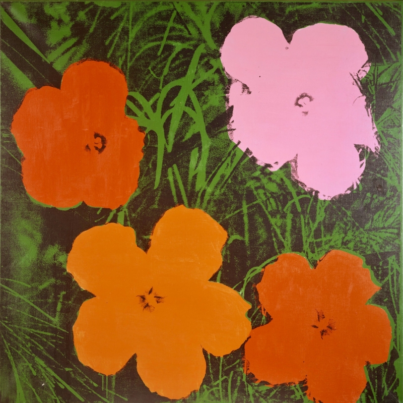 The picture shows four colorful flowers on a green background.
One flower is pink, two are orange and one is red.
The background is dark green with grass and leaves.
The picture is by Andy Warhol, a famous pop artist.
He used synthetic polymer paint and screen printing.
This means that he applied colors and printed the motif with a stencil.