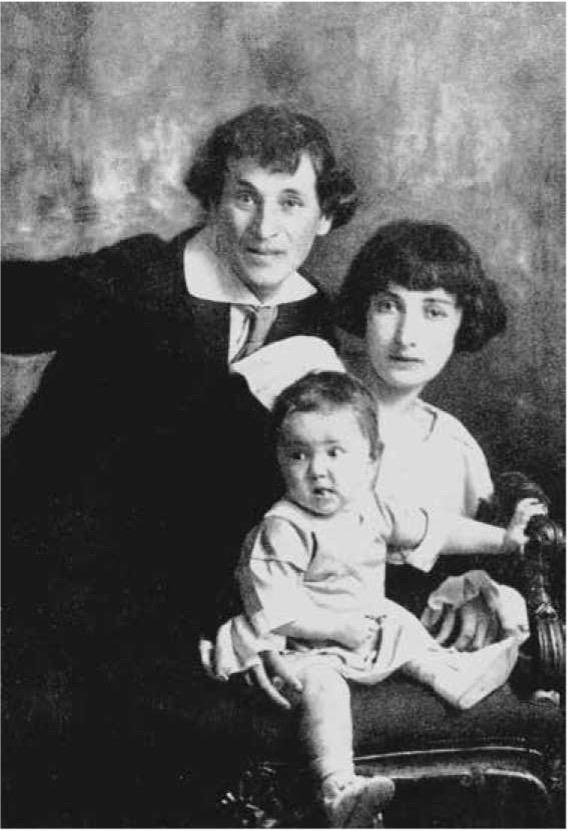 A man and woman pose with a baby on a chair, set against a textured backdrop, all displaying serious expressions.