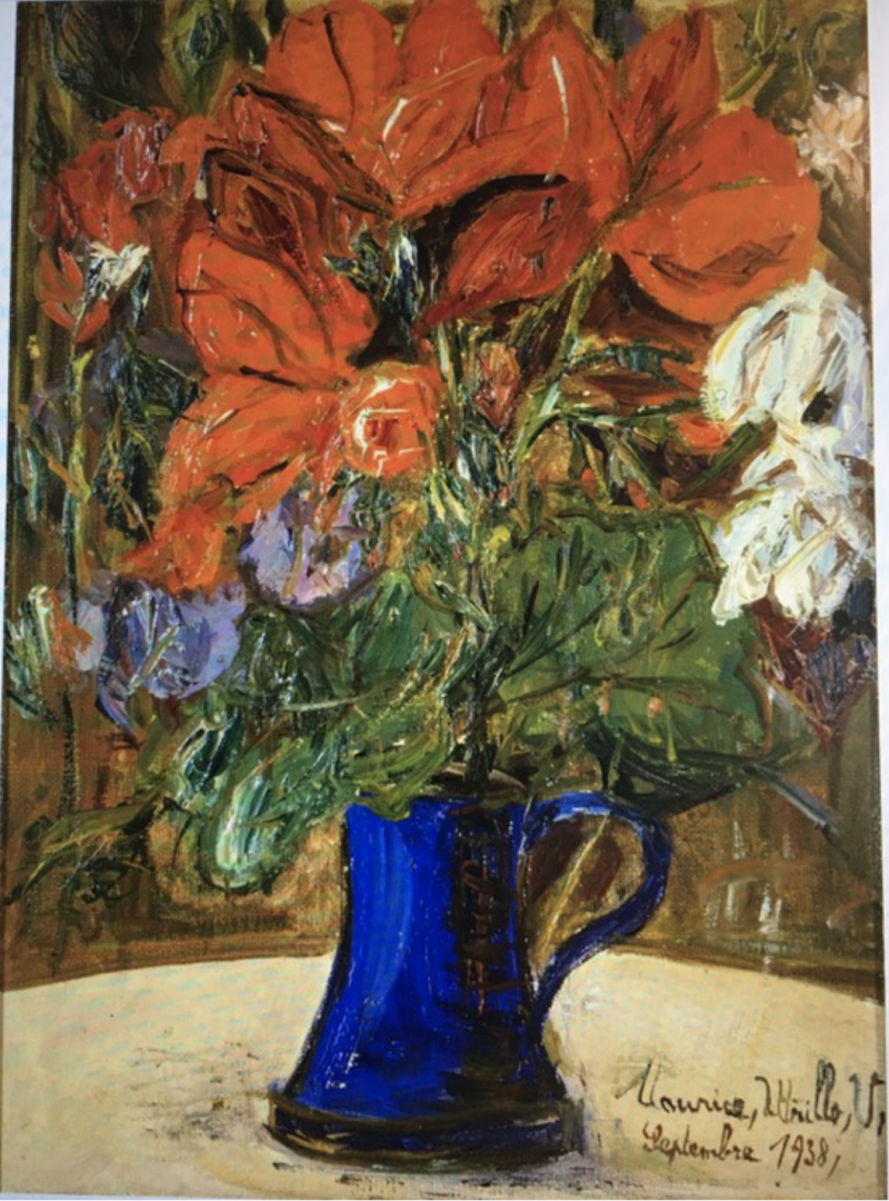 Vibrant red flowers and white blooms in a blue vase, set against a textured brown background.