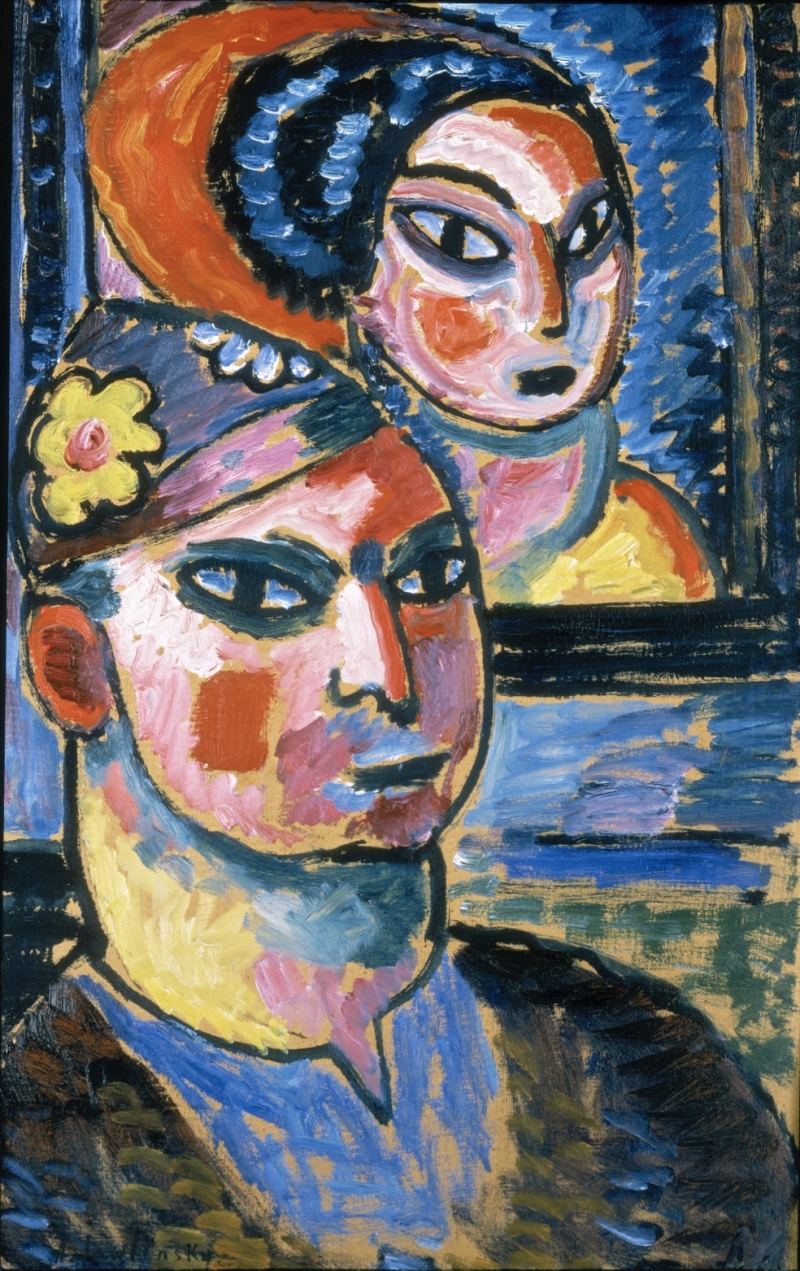 A colorful portrait featuring a man with a flower in his hair and a woman with bold features in the background.