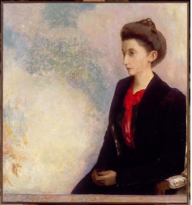 Porträt einer Frau mit dunklem Kleid und rotem Schal, vor einem sanften, pastellfarbenen Hintergrund.